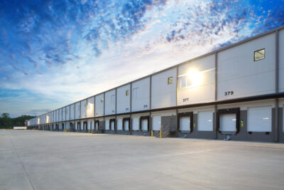 Exterior of modern distribution center warehouse at sunrise